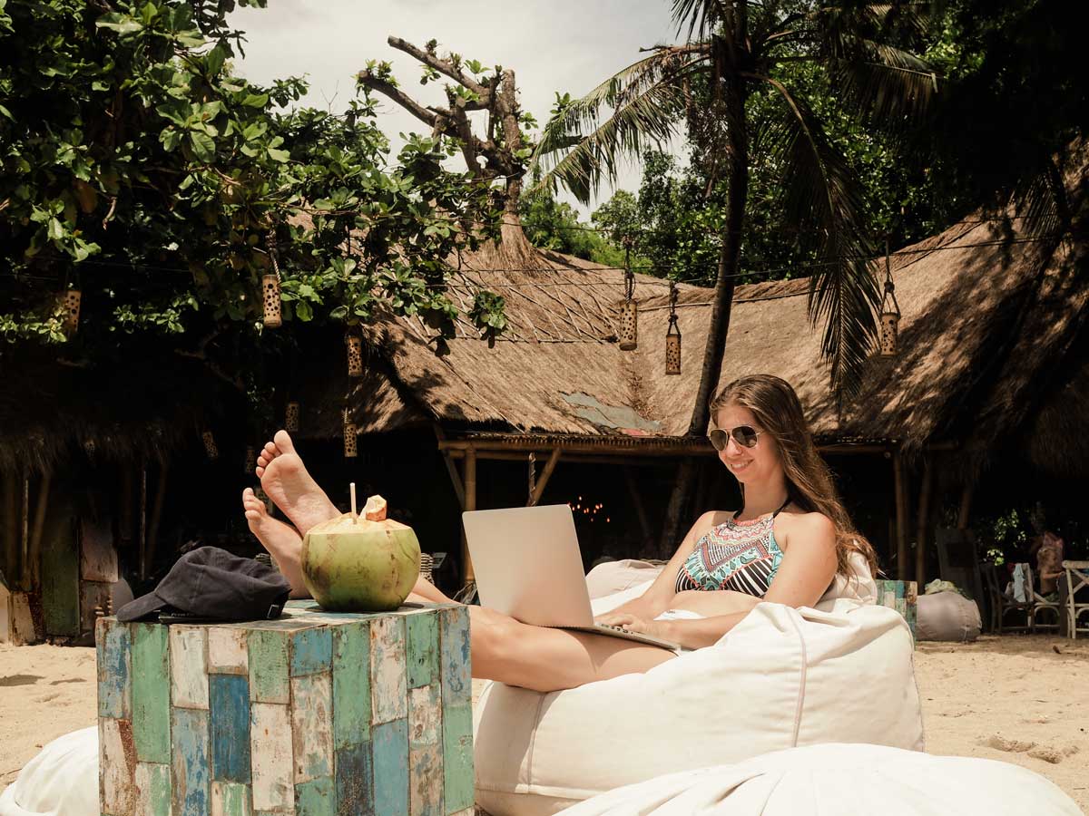 Woman chilling in a resort win laptop on her lap